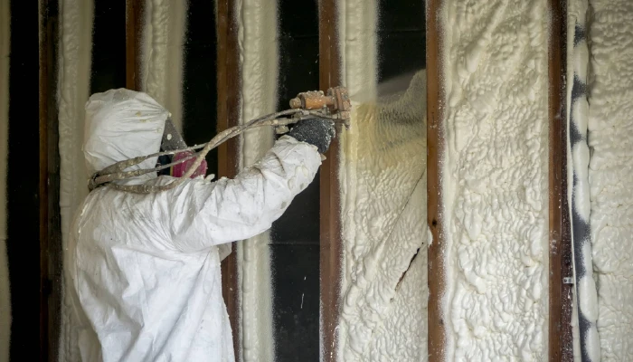 technician installing attic insulation